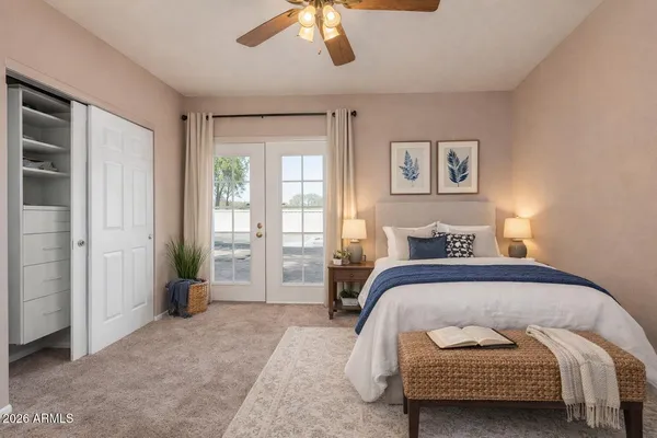 a bedroom with a bed and a chandelier