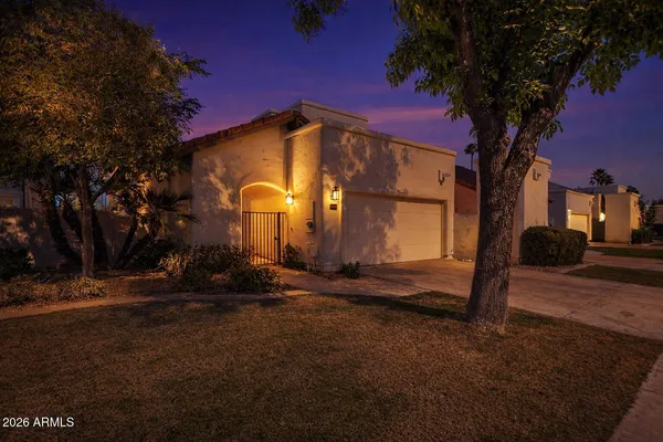a backyard of a house with table and chairs