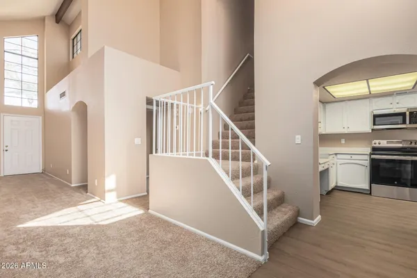 a view of a hallway with kitchen and entryway