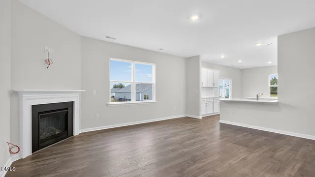 a view of kitchen with wooden floor and electronic appliances