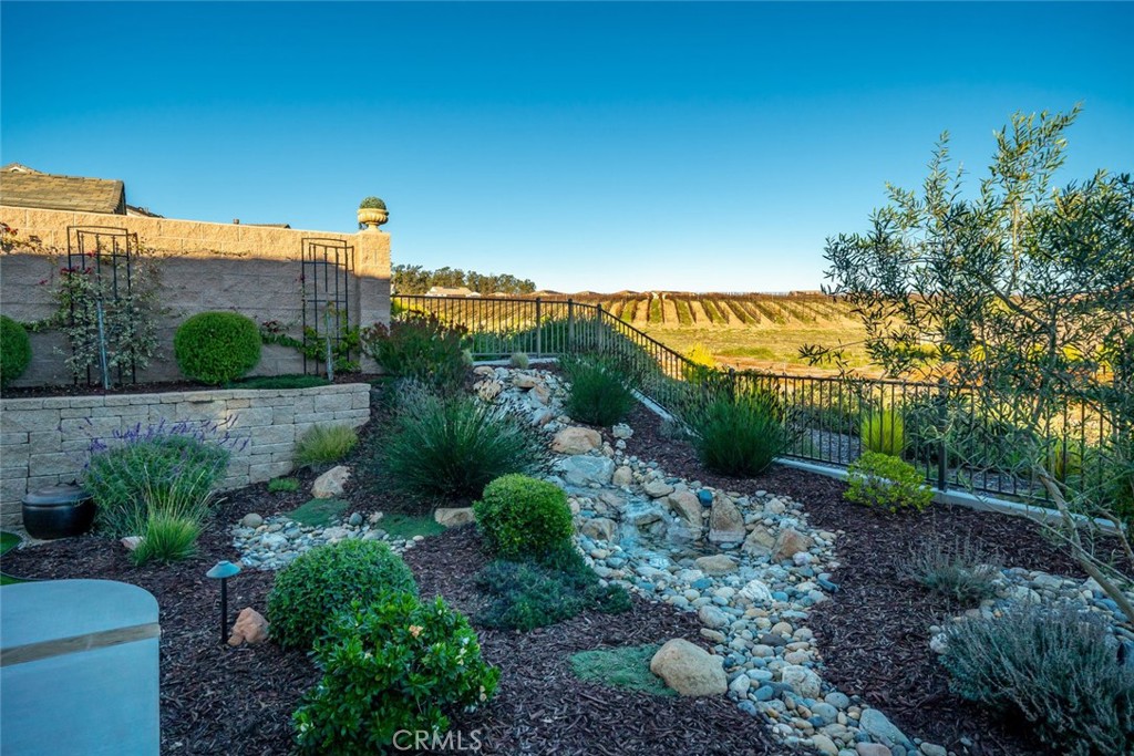 1035 Gavin Lane Nipomo, CA 93444 - Photo 22 of 70 a view of a garden with a building in the background