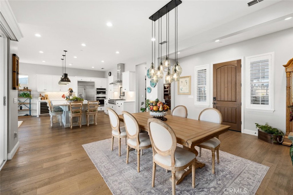 1035 Gavin Lane Nipomo, CA 93444 - Photo 28 of 70 a dining room with furniture a chandelier and wooden floor