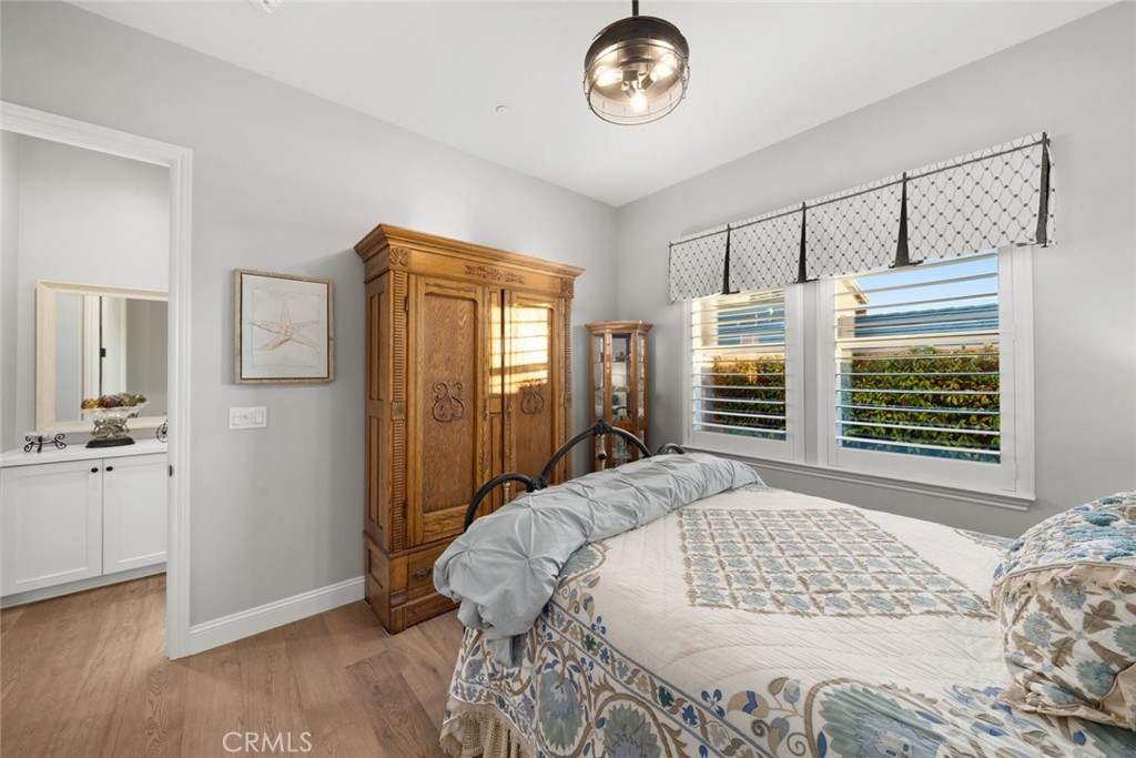 1035 Gavin Lane Nipomo, CA 93444 - Photo 37 of 70 a bedroom with a large bed and a chandelier