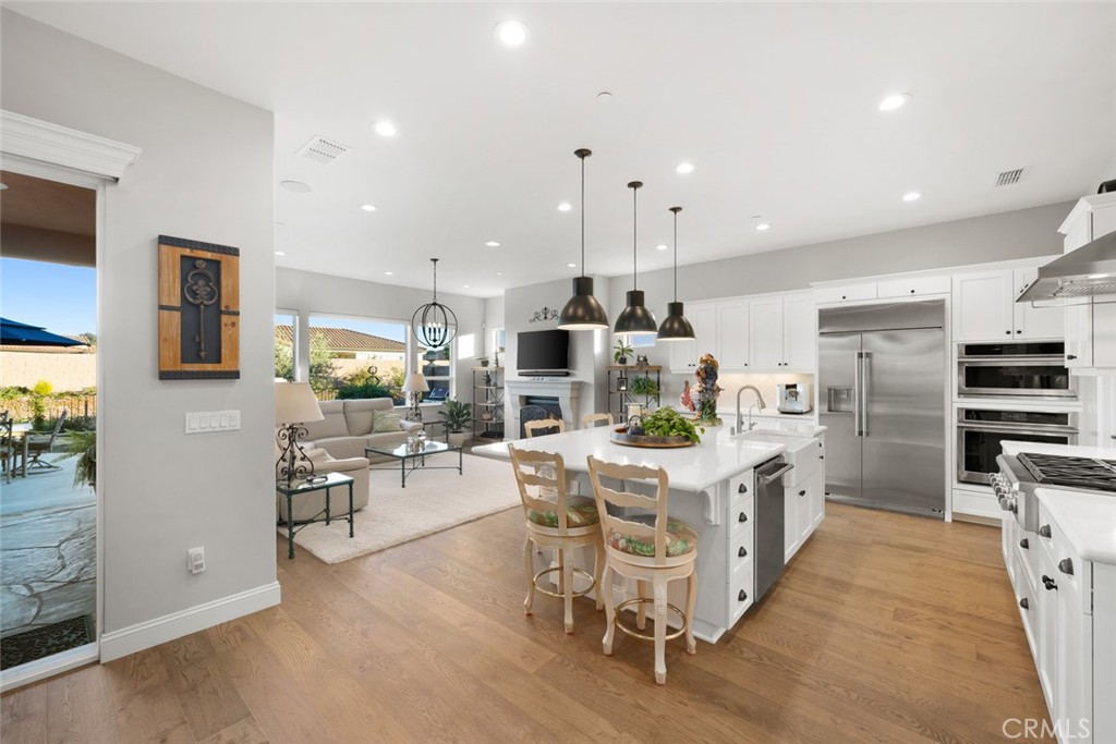 1035 Gavin Lane Nipomo, CA 93444 - Photo 6 of 70 a kitchen with stainless steel appliances kitchen island granite countertop a table and chairs in it