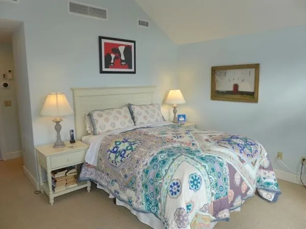 a bedroom with bed and a lamp