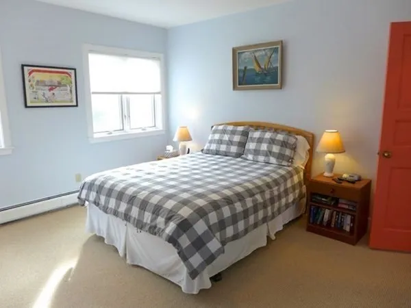 a bedroom with a bed and window