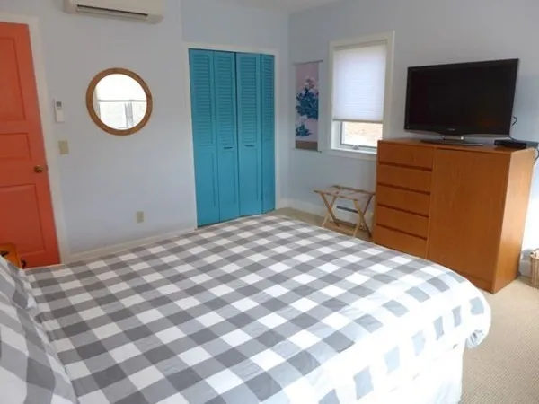 a bedroom with a bed and a flat screen tv