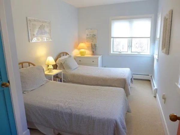 a bedroom with bed and a window