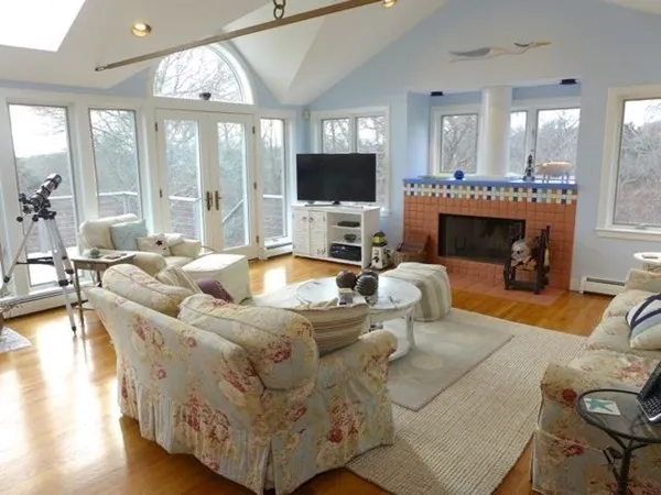 a living room with furniture a fireplace and a flat screen tv