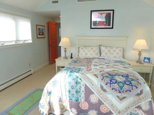 a bedroom with a bed and a lamp