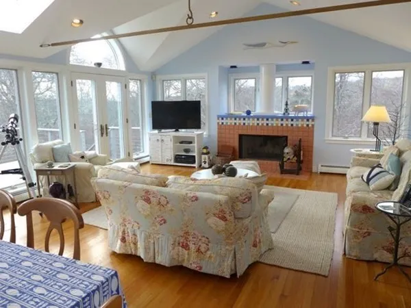 a living room with furniture a flat screen tv and a fireplace