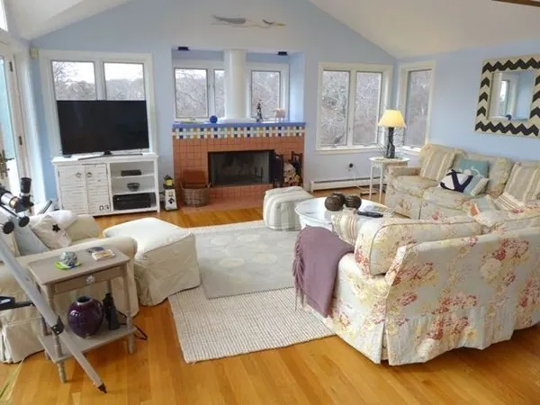 a living room with furniture flat screen tv and a fireplace