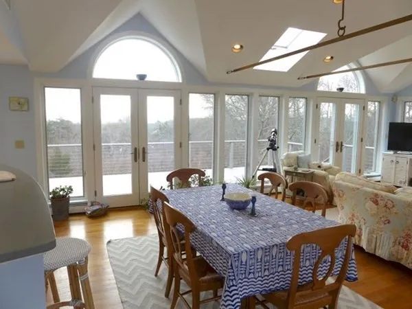 a dining room with furniture a chandelier and wooden floor
