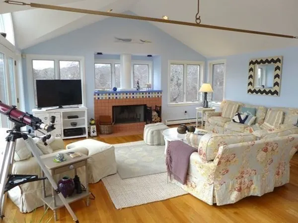 a living room with furniture a flat screen tv and a fireplace