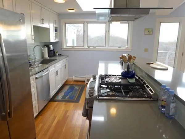 a kitchen with sink refrigerator and window