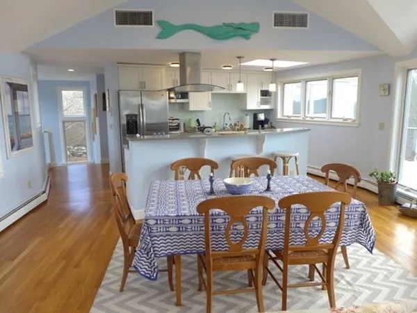 a dining room with furniture and wooden floor