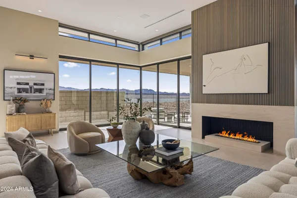 a large bedroom with a large bed and glass windows