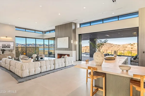 a kitchen with a sink and chairs