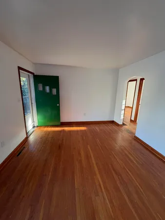 a view of a room with wooden floor and stairs