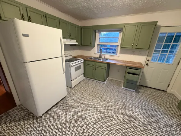 a white refrigerator freezer sitting inside of a kitchen