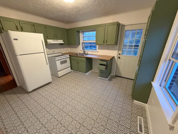 a bathroom with a toilet a sink a mirror and a shower