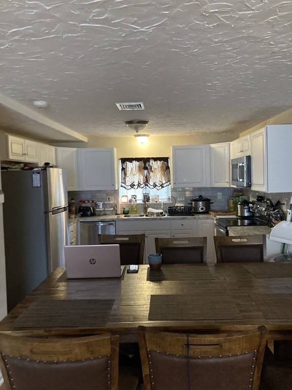 5455 North Main Street, Unit 18B Fall River, MA 02720 - Photo 1 of 2 a kitchen with stainless steel appliances granite countertop a stove a refrigerator a sink a stove and white cabinets with wooden floor