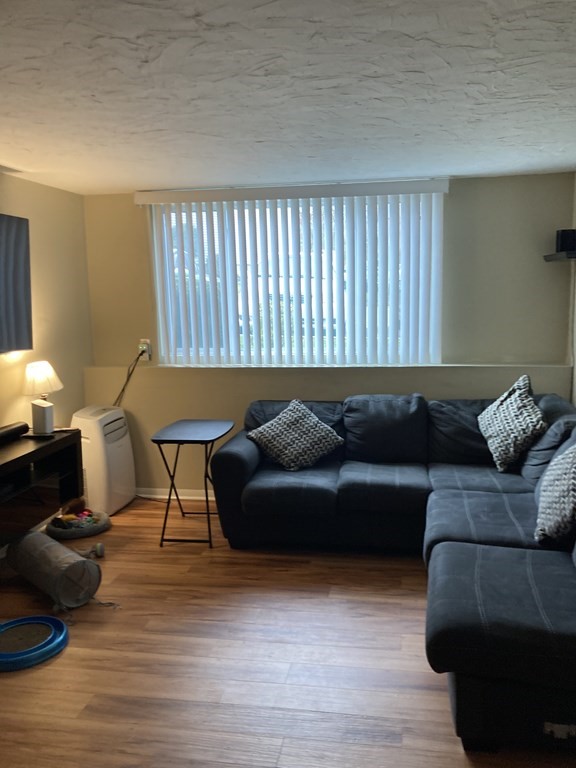5455 North Main Street, Unit 18B Fall River, MA 02720 - Photo 2 of 2 a living room with furniture and a wooden floor