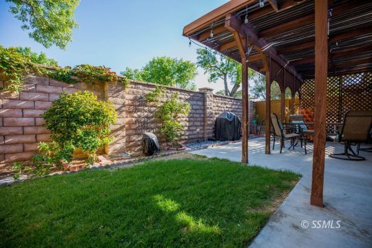 415 Tepatitlan Court Ridgecrest, CA 93555 - Photo 27 of 33 a view of a backyard with plants and a patio