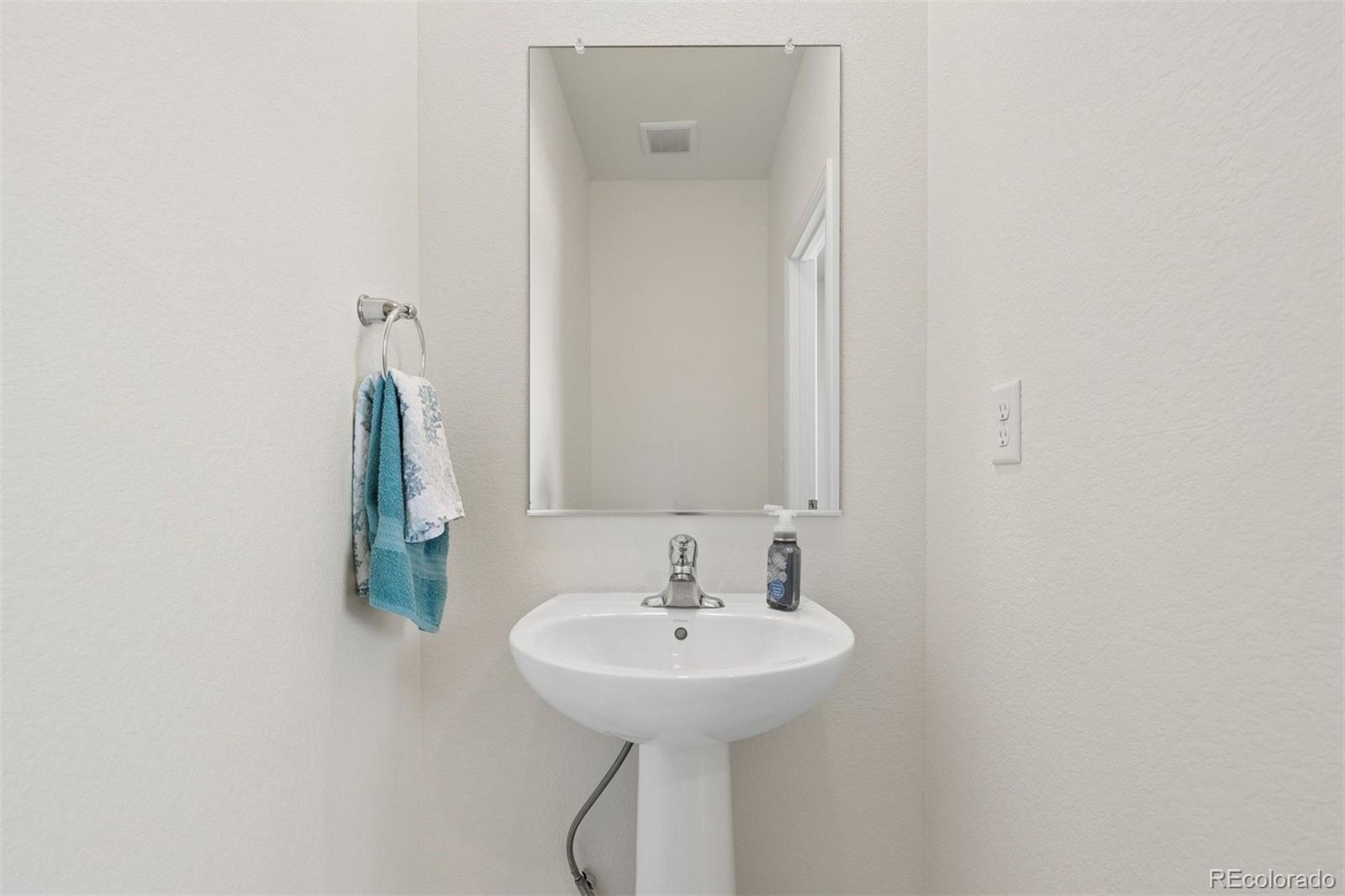 7307 Animas Avenue Frederick, CO 80530 - Photo 21 of 49 a bathroom with a sink and a mirror