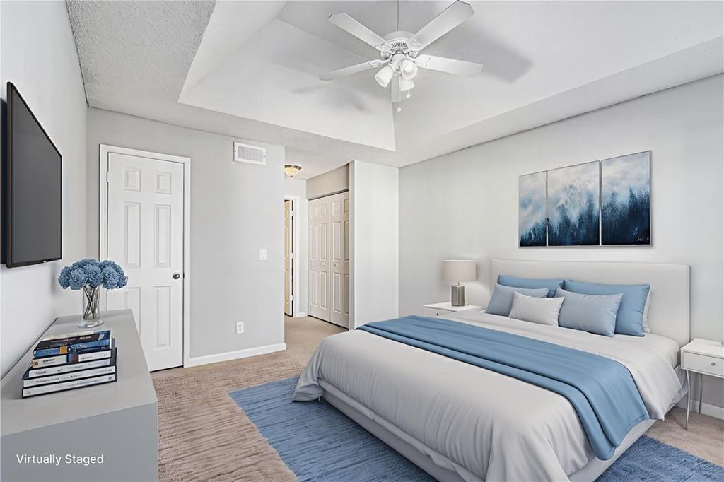 2657 Lenox Road Northeast, Unit 69 Atlanta, GA 30324 - Photo 13 of 31 a bedroom with a bed and a chandelier