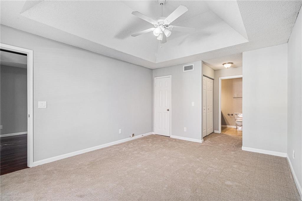2657 Lenox Road Northeast, Unit 69 Atlanta, GA 30324 - Photo 14 of 31 an empty room with a ceiling fan and a window