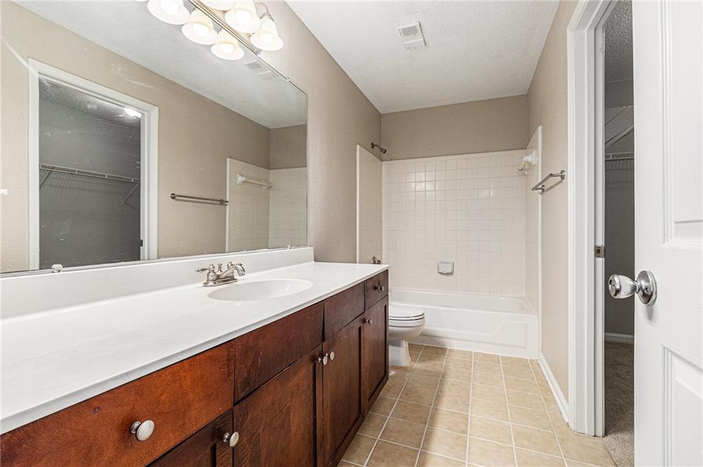 2657 Lenox Road Northeast, Unit 69 Atlanta, GA 30324 - Photo 25 of 31 a bathroom with a double vanity sink mirror double and shower