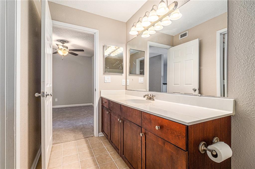 2657 Lenox Road Northeast, Unit 69 Atlanta, GA 30324 - Photo 26 of 31 a bathroom with a sink vanity and a mirror
