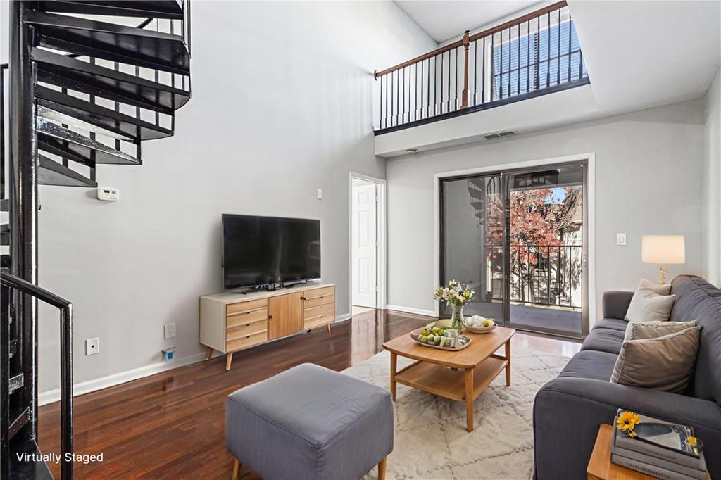 2657 Lenox Road Northeast, Unit 69 Atlanta, GA 30324 - Photo 4 of 31 a living room with furniture a flat screen tv and a window