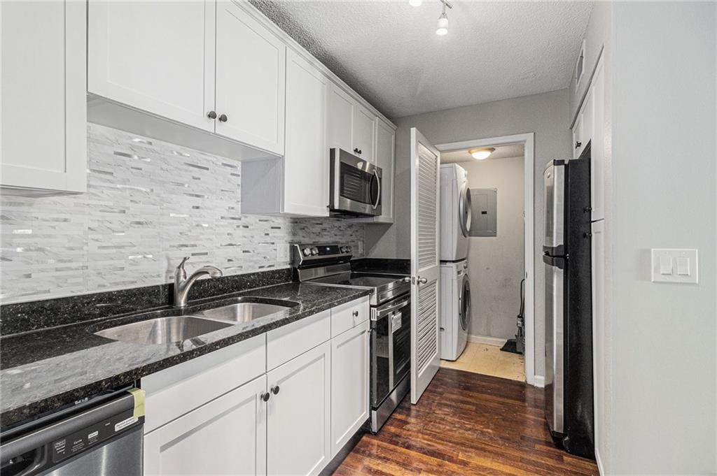 2657 Lenox Road Northeast, Unit 69 Atlanta, GA 30324 - Photo 10 of 31 a kitchen with sink a refrigerator and cabinets