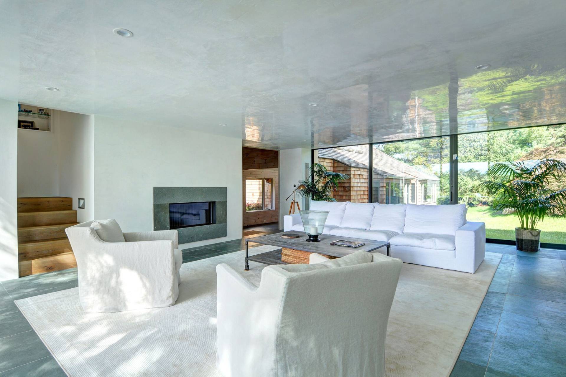 635 Lumber Lane Bridgehampton, NY 11932 - Photo 13 of 27 a living room with furniture large window and a fireplace