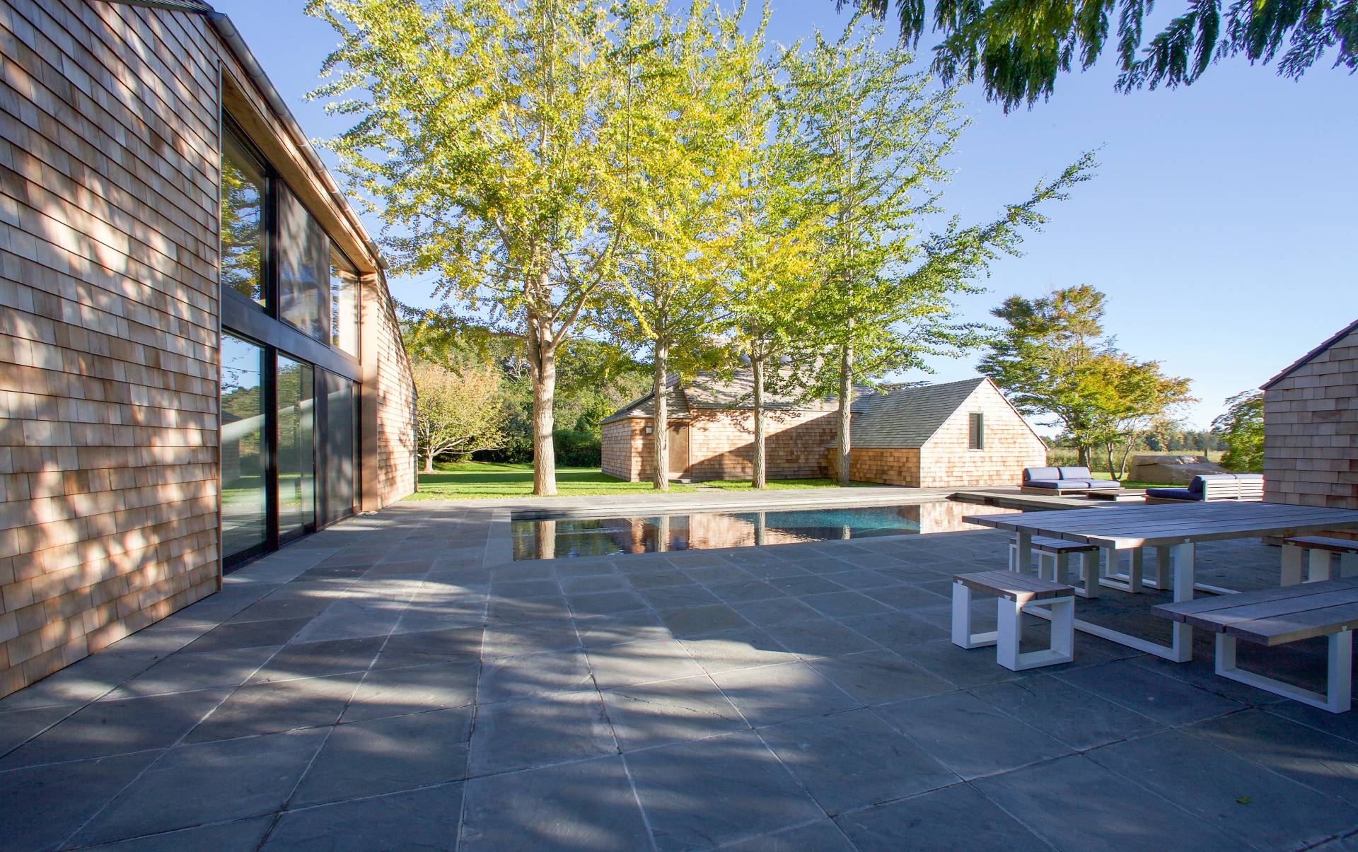 635 Lumber Lane Bridgehampton, NY 11932 - Photo 20 of 27 a view of a yard with a table and chairs