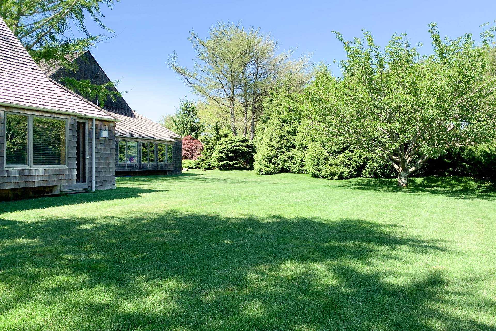 635 Lumber Lane Bridgehampton, NY 11932 - Photo 27 of 27 a view of a garden with a house