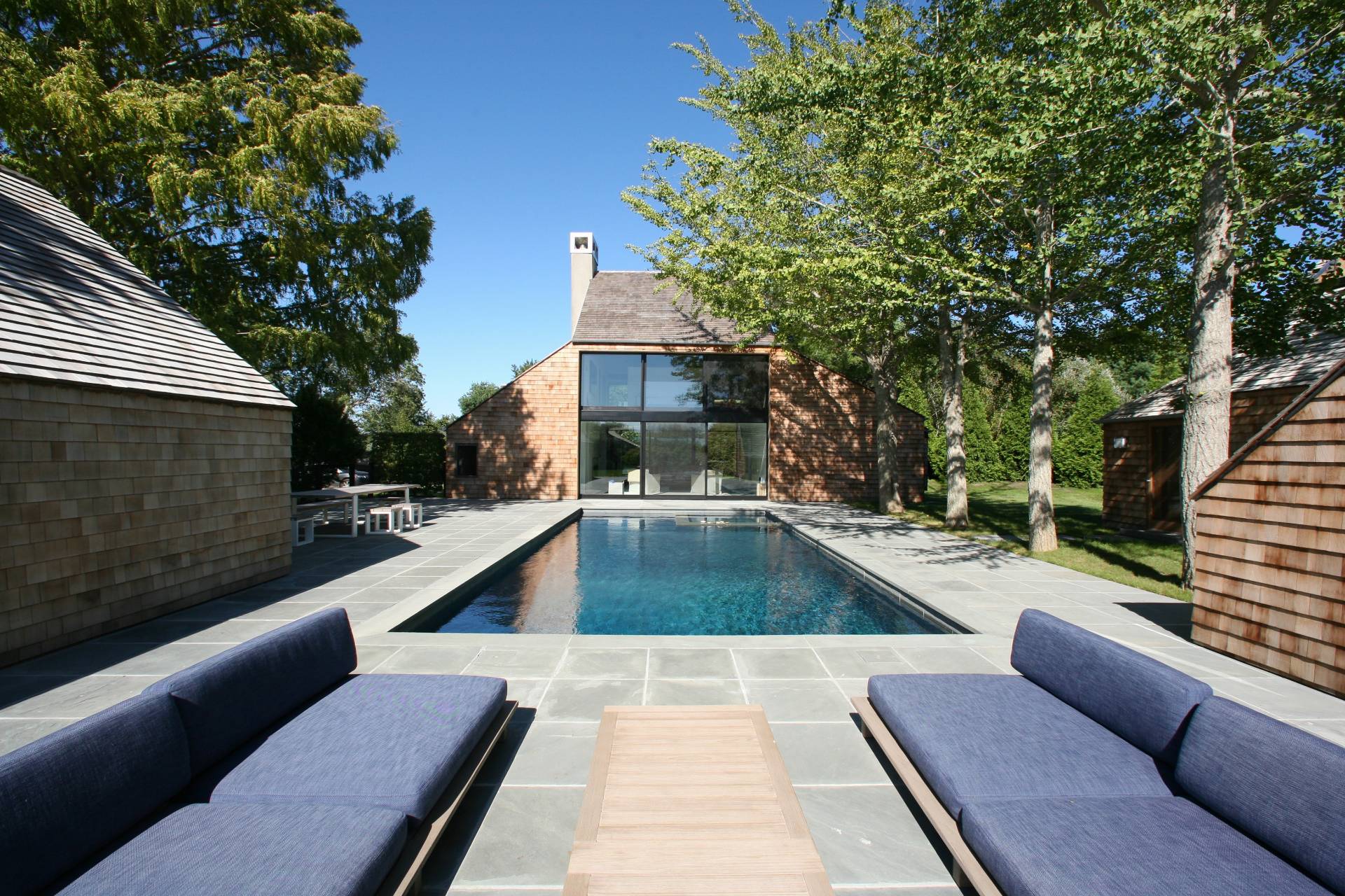 635 Lumber Lane Bridgehampton, NY 11932 - Photo 5 of 27 a view of a patio with couches and a potted plant on a table