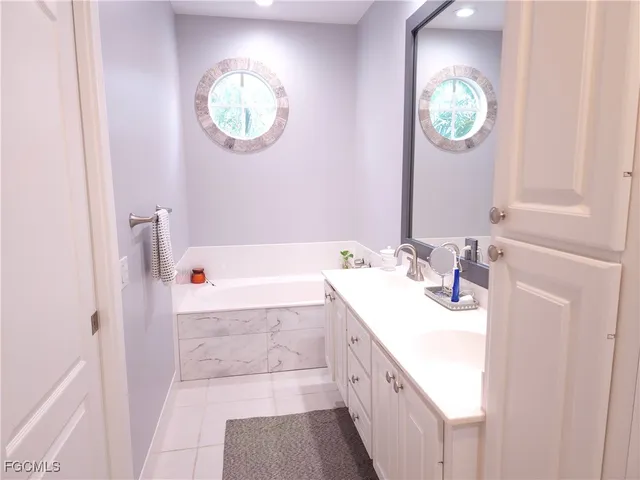 a bathroom with a sink a vanity and a mirror