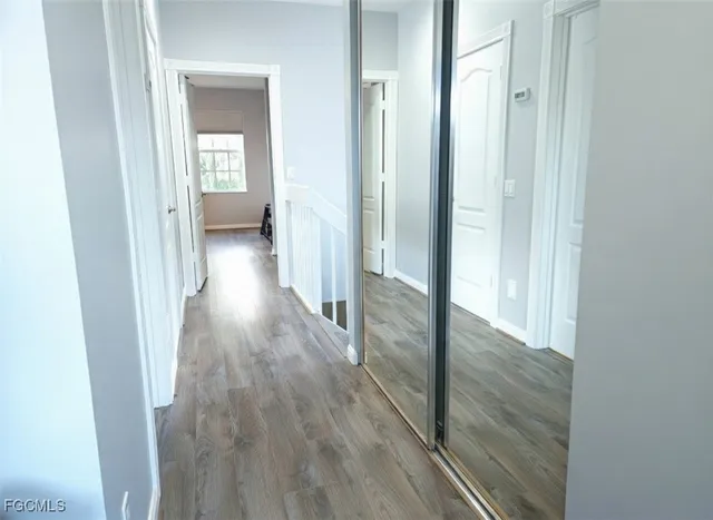 a view of a hallway with wooden floor