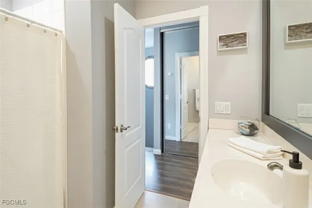 a bathroom with a tub sink and mirror