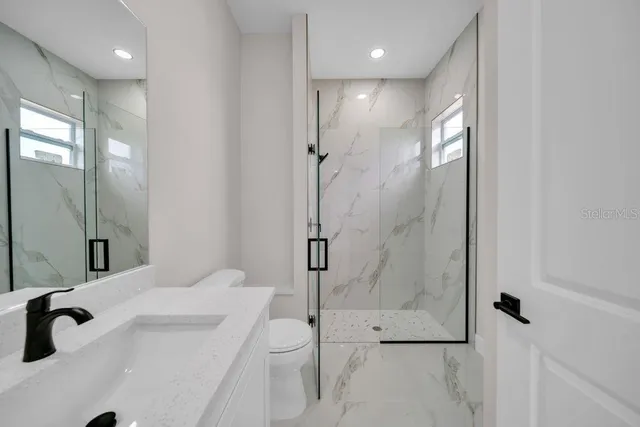 a bathroom with a shower and a toilet