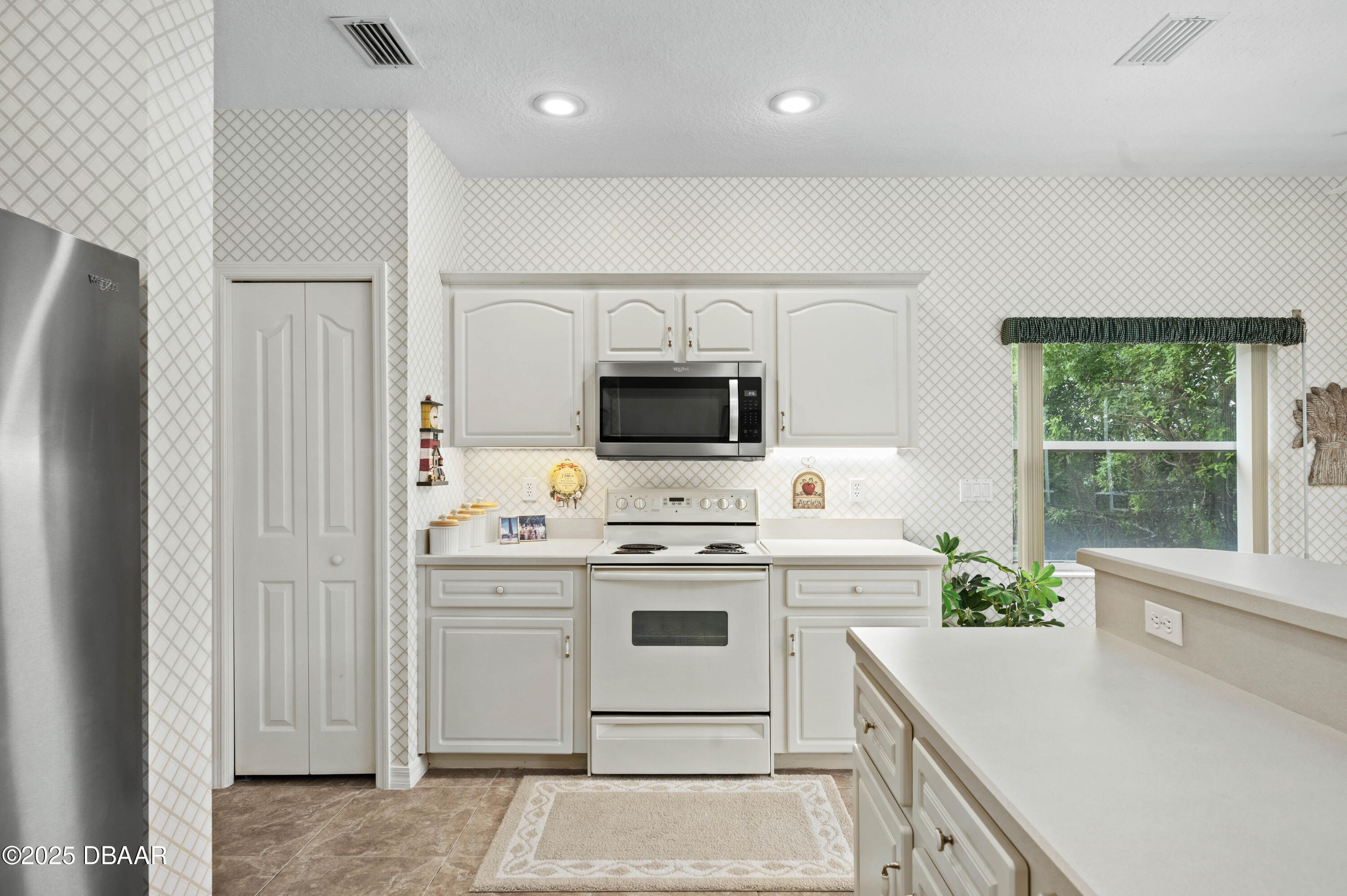 38 South Turn Circle Ponce Inlet, FL 32127 - Photo 11 of 49 a kitchen with a stove a sink and a refrigerator