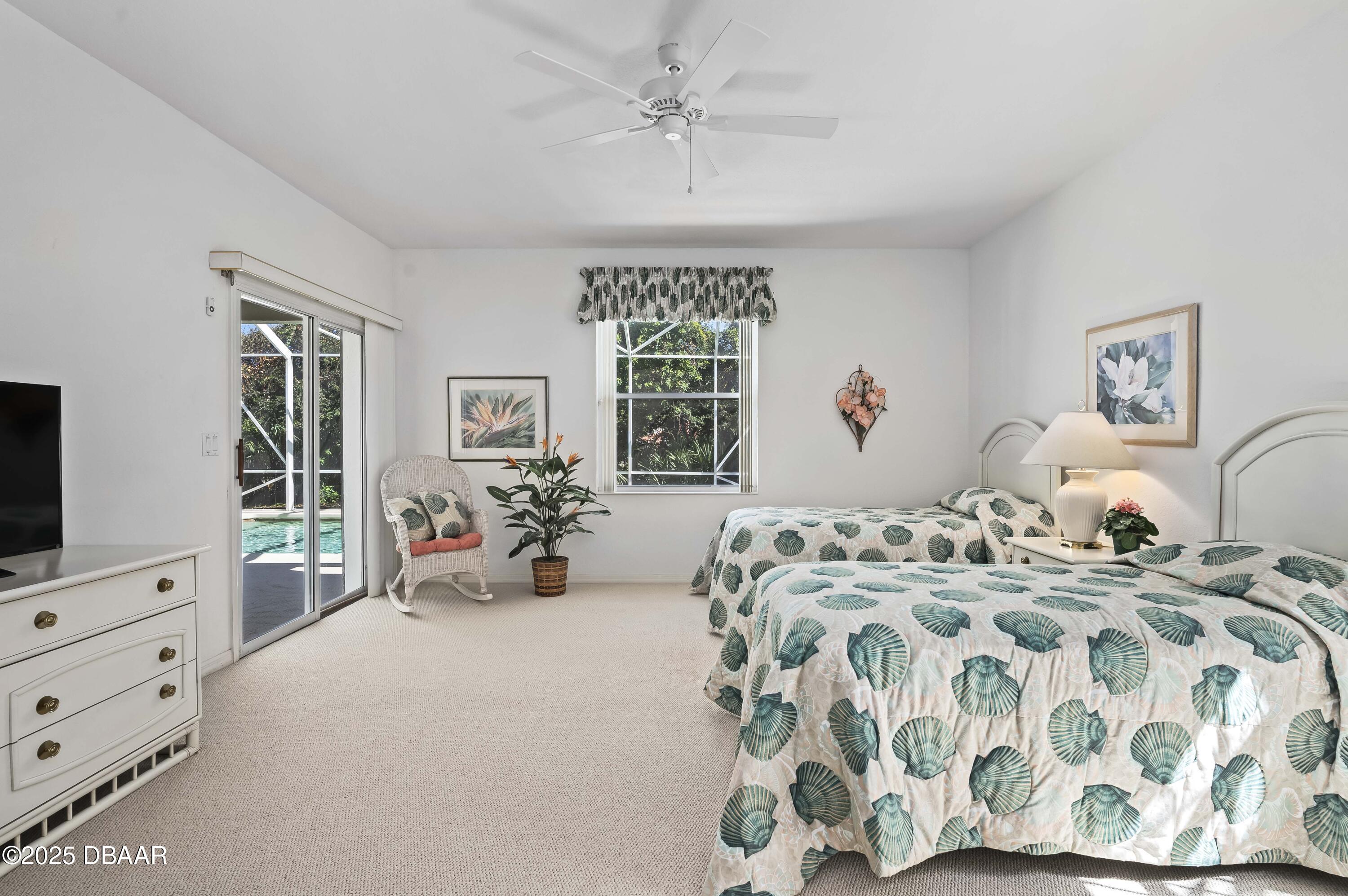 38 South Turn Circle Ponce Inlet, FL 32127 - Photo 14 of 49 a bedroom with bed and glass door