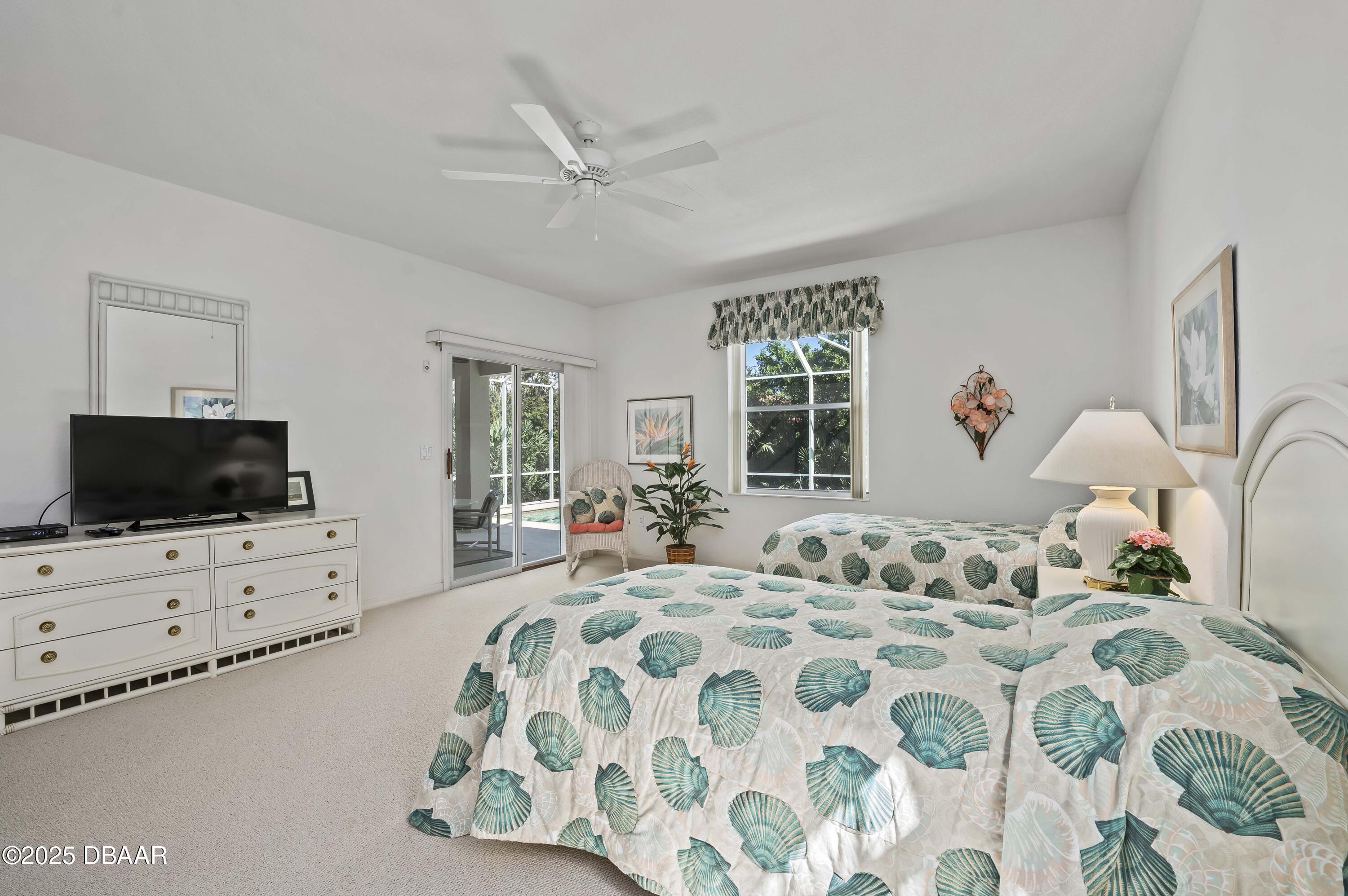 38 South Turn Circle Ponce Inlet, FL 32127 - Photo 15 of 49 a bedroom with bed tv and window