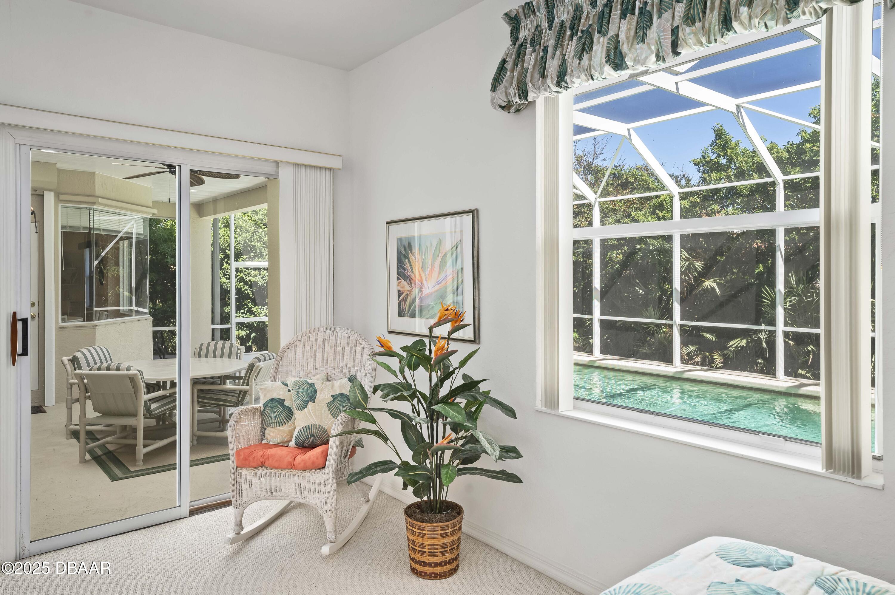 38 South Turn Circle Ponce Inlet, FL 32127 - Photo 16 of 49 a vase of flowers sitting next to a window