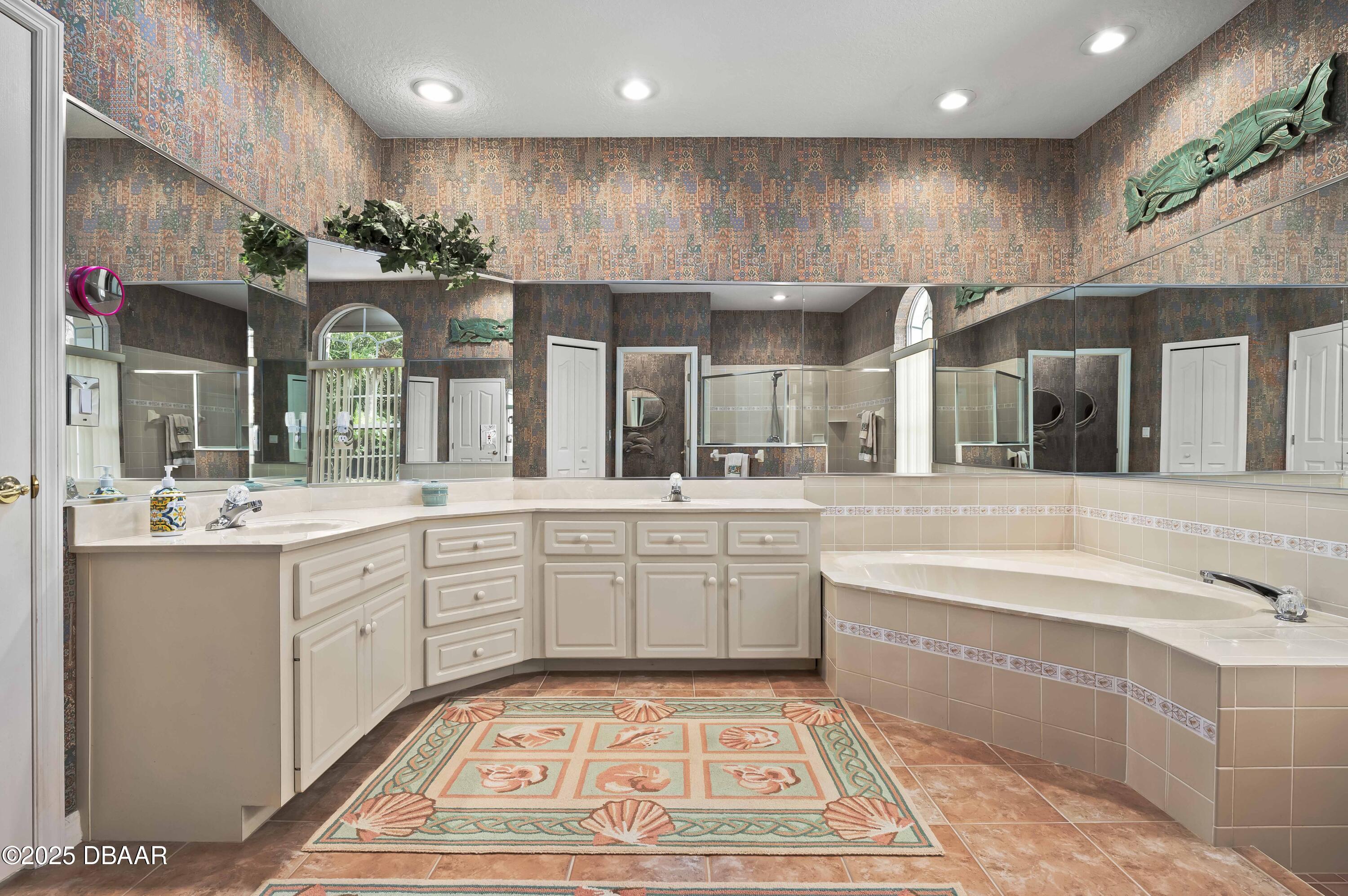 38 South Turn Circle Ponce Inlet, FL 32127 - Photo 19 of 49 a large bathroom with a large tub and sink