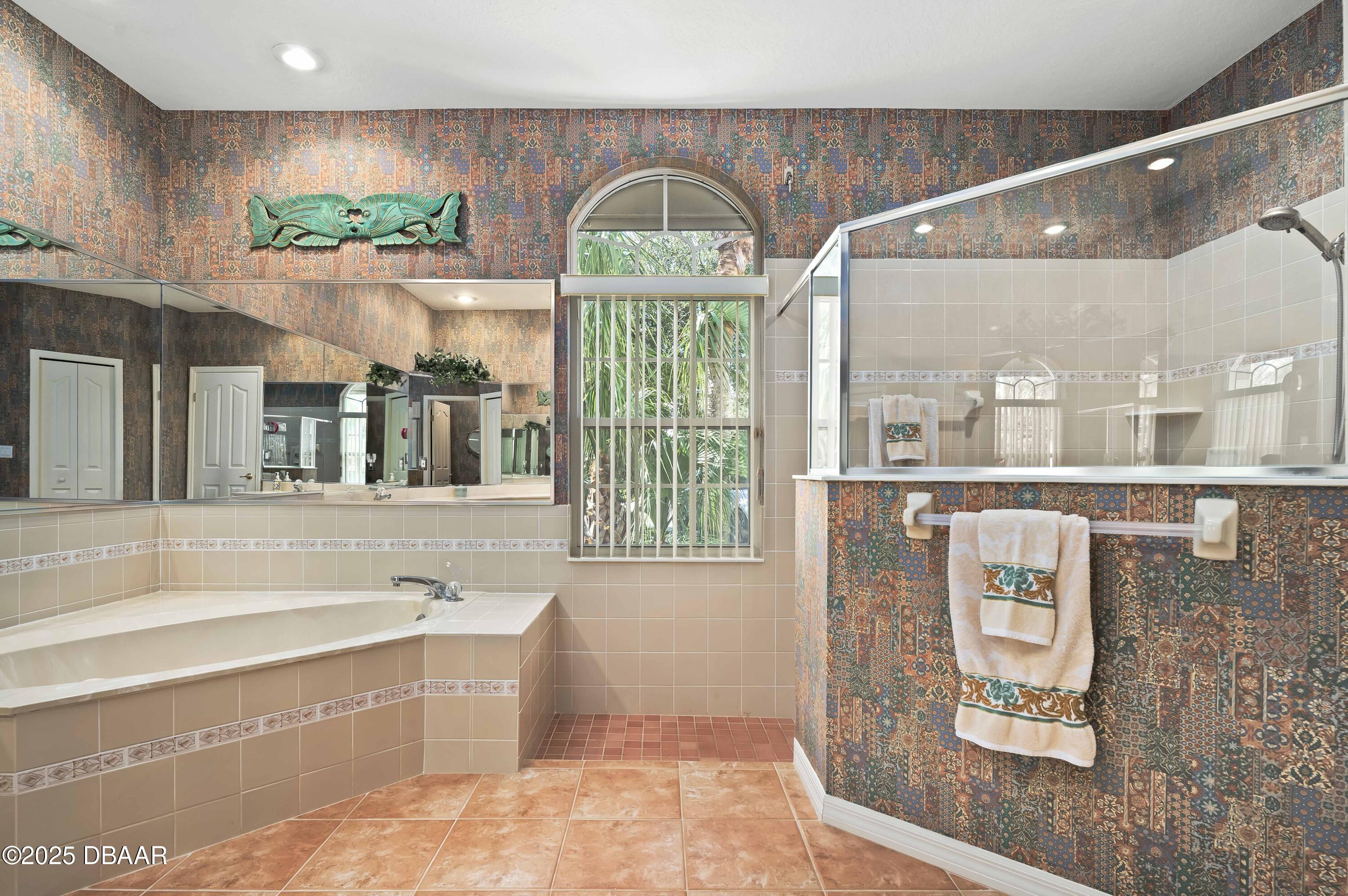 38 South Turn Circle Ponce Inlet, FL 32127 - Photo 20 of 49 a bathroom with a tub and a large window