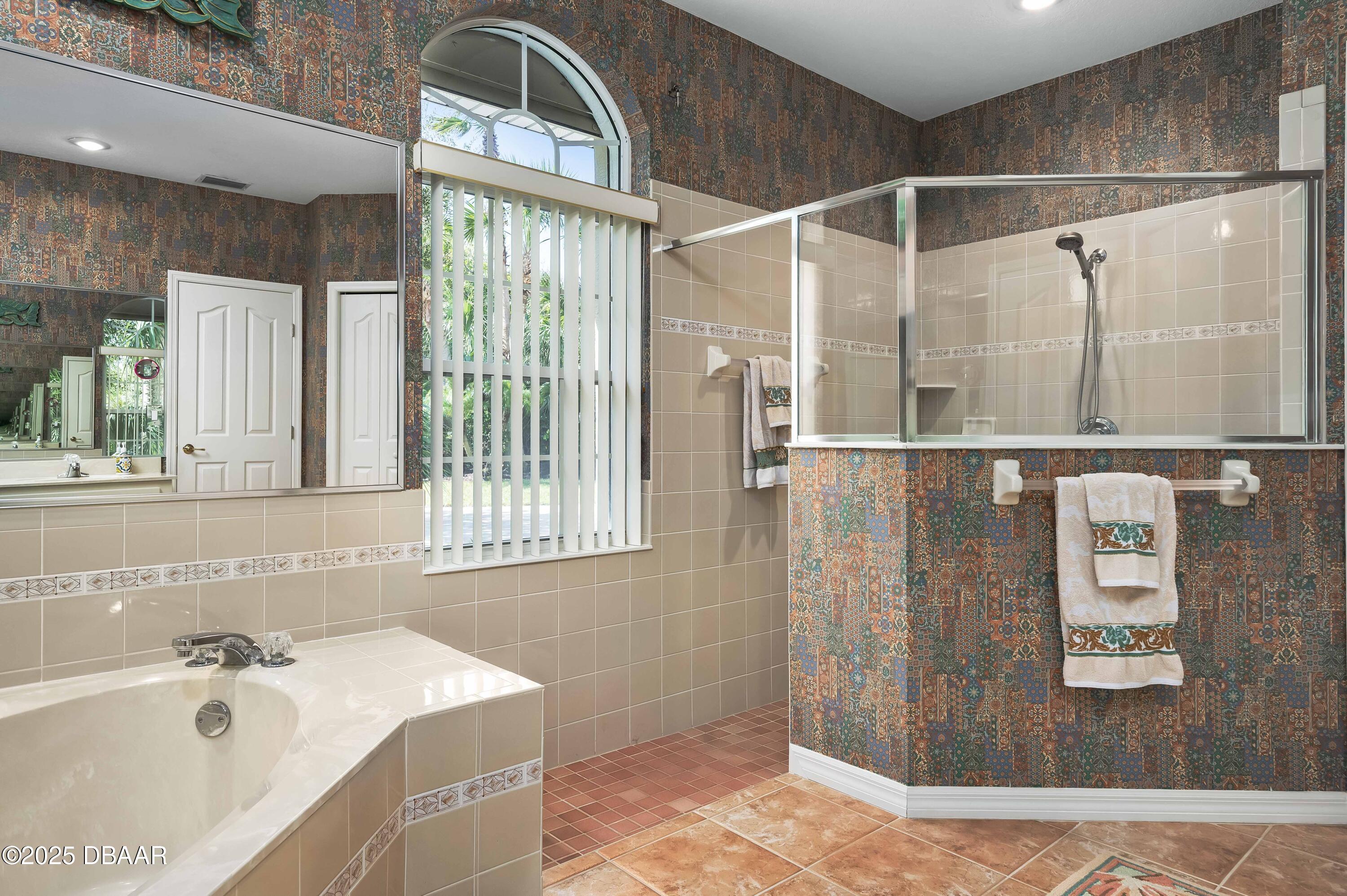 38 South Turn Circle Ponce Inlet, FL 32127 - Photo 21 of 49 a bathroom with a tub sink and mirror